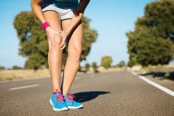 Runner holding knee due to chronic pain