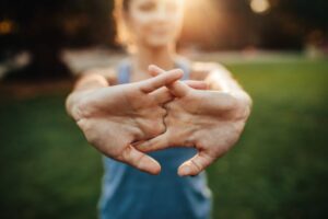 Women with hands out stretching her arms and shoulders