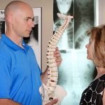 Dr. Cain discussing chiropractic treatment with patient